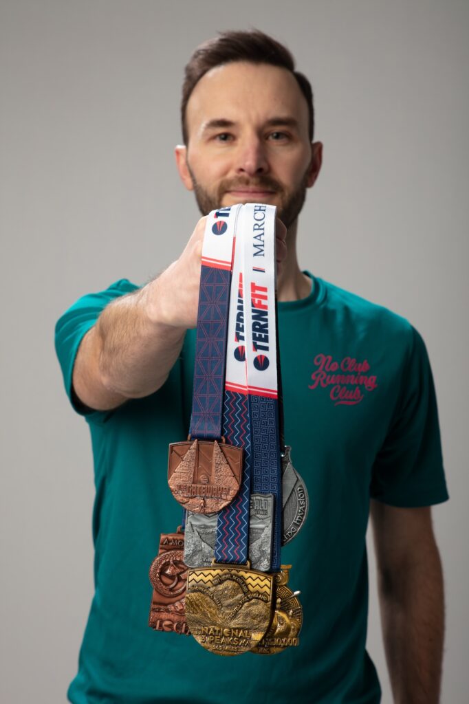 a man holding medals